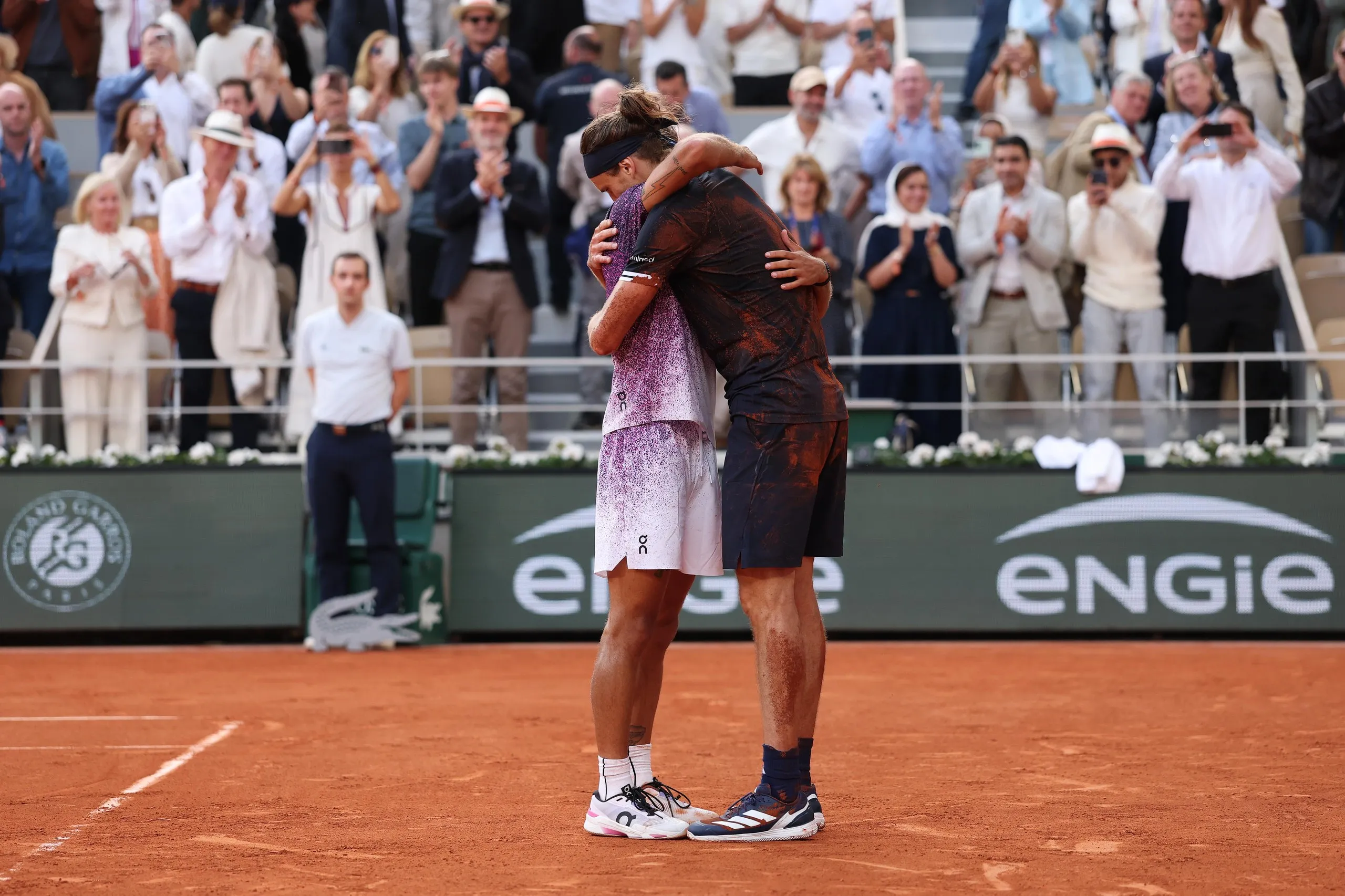 Flavio Cobolli and Alexander Zverev embrace after Zverev’s victory in Paris